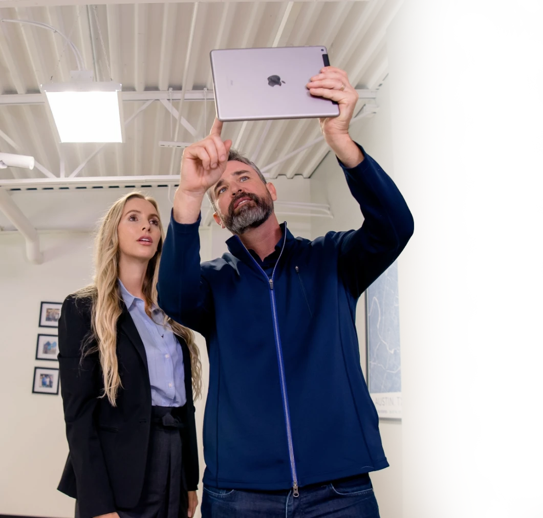Professionals reviewing a site survey on tablet